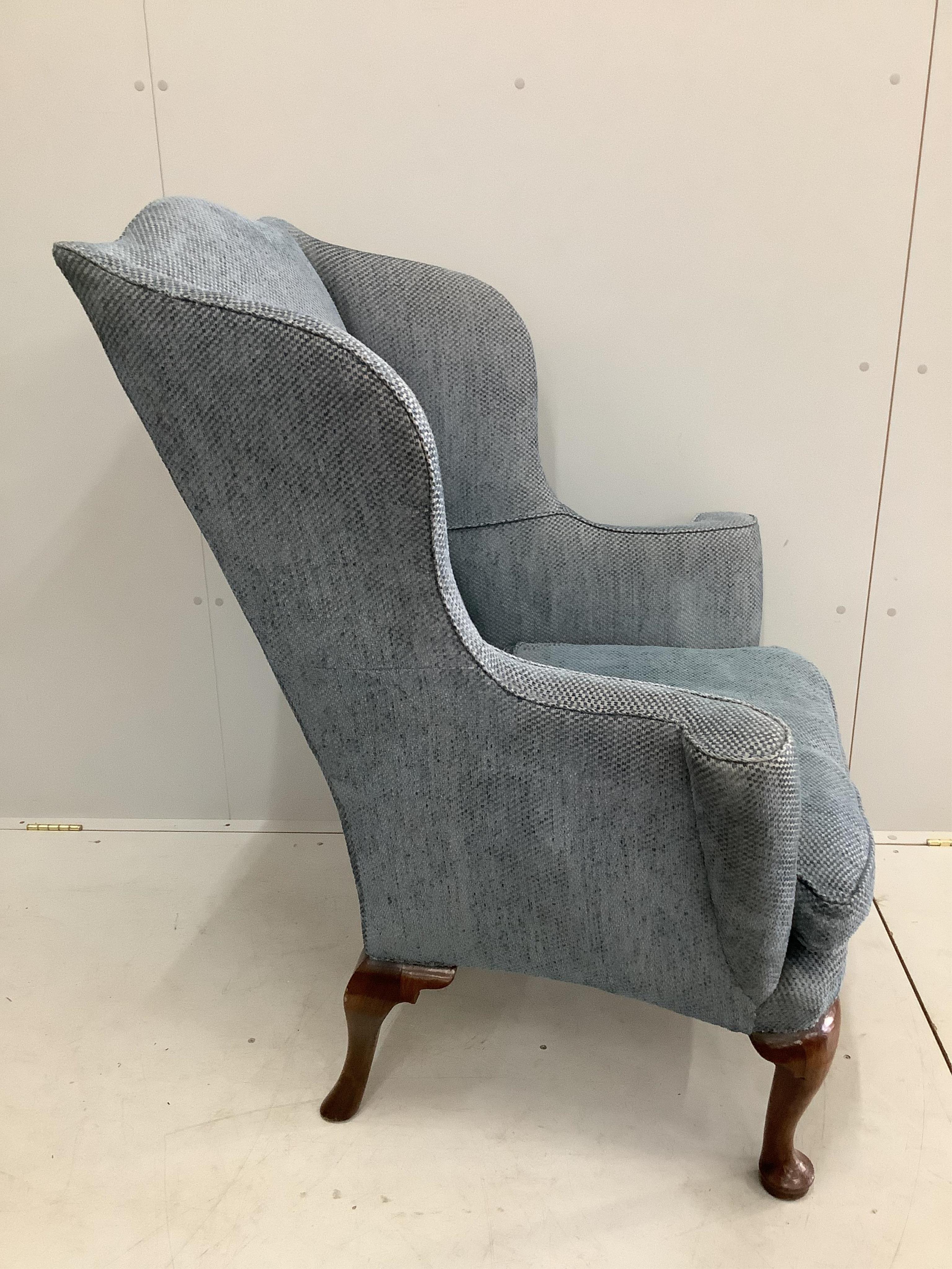 A George I walnut wing armchair, upholstered in blue fabric. Condition - good